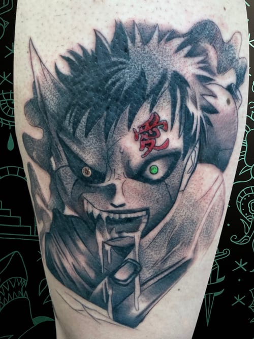 An anime-inspired black and grey tattoo on the leg, featuring a character's intense face with a glowing green eye and red symbol on the forehead — by Josue Bravo, los angeles