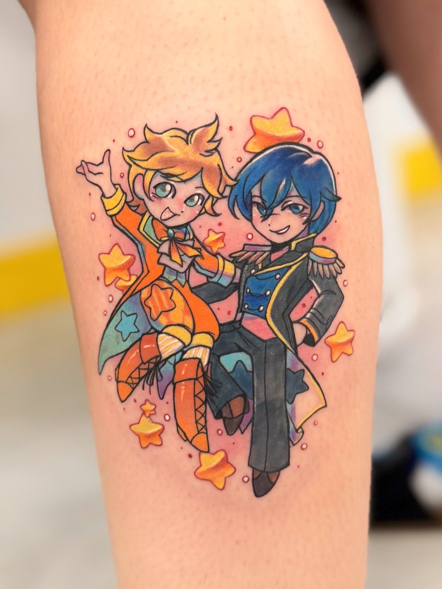 A colorful anime-style tattoo of two characters surrounded by stars on the leg, featuring vibrant colors and a playful design — by Tweetwee, los angeles