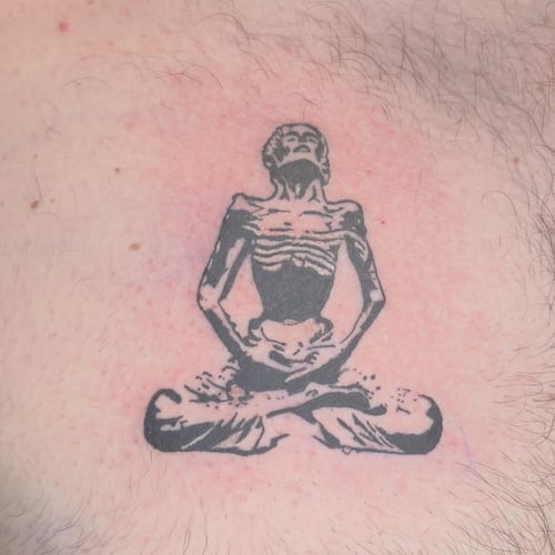 A minimalist blackwork tattoo of a skeleton in a meditation pose, featuring dark and bold lines — by Hannah , los angeles