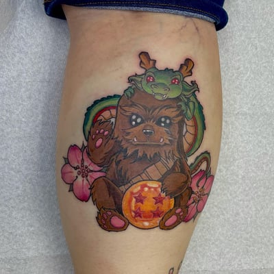 A colorful new school tattoo of a cute creature with a dragon and flowers on the leg, featuring bold lines and vibrant colors — by Sandra Price, los angeles