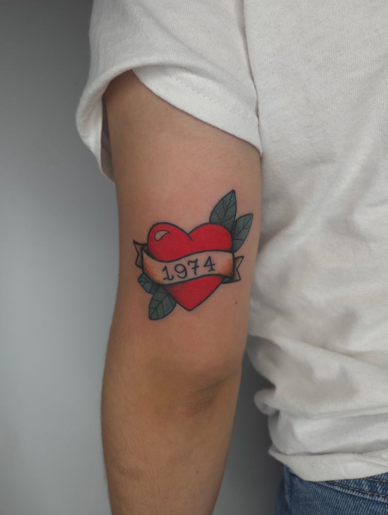 american traditional red heart and banner tattoo reading 1974 with green leaves by ashynucklestattoo, a traditional tattoo artist in eagle rock los angeles