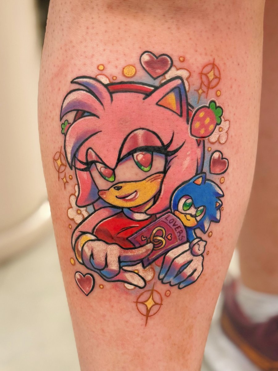 A colorful tattoo of Amy Rose from the Sonic series on the calf, featuring a vibrant pop art style with hearts and strawberries — by Tweetwee, los angeles
