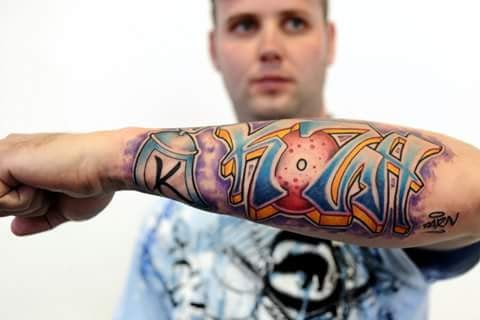 A bold and colorful graffiti style lettering tattoo on the forearm — by Samuel Connelly, san diego, ca
