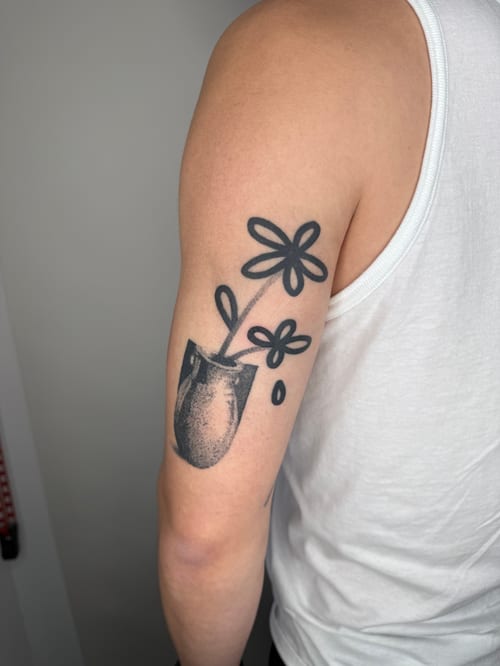 minimalist flower in a vase tattoo — by Level tattoo, los angeles
