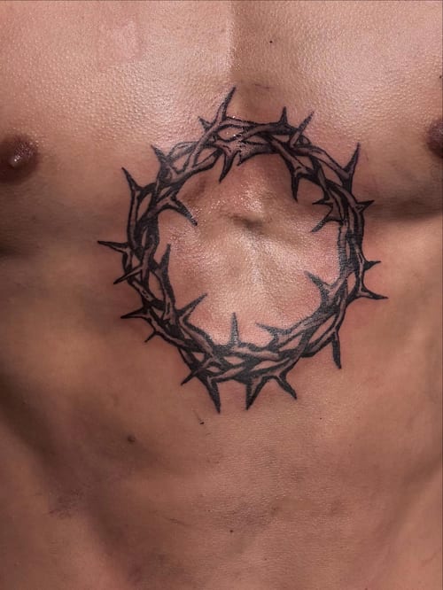 A bold blackwork crown of thorns tattoo on the chest, featuring sharp and minimalist design elements — by Hannah , los angeles