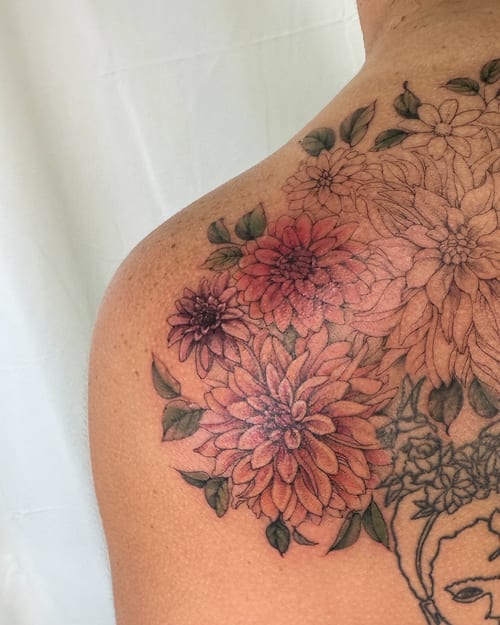 A colorful floral bouquet tattoo on the shoulder with detailed blackwork outlines and delicate shading — by Melanie Benoit, los angeles