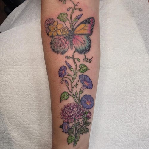 A colorful butterfly with chrysanthemum and morning glory flowers on the forearm in an illustrative style — by Sandra Price, los angeles
