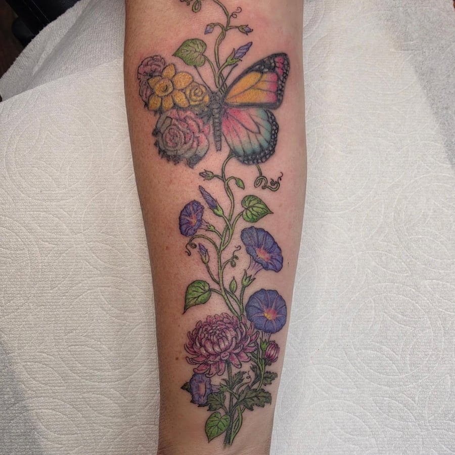 A colorful butterfly with chrysanthemum and morning glory flowers on the forearm in an illustrative style — by Sandra Price, los angeles