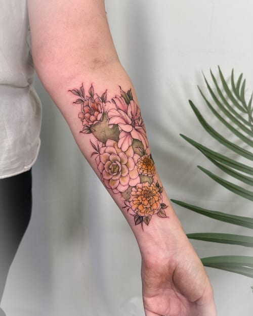 A colorful floral arrangement tattoo on the forearm with delicate fine line work and vibrant colors — by Melanie Benoit, los angeles