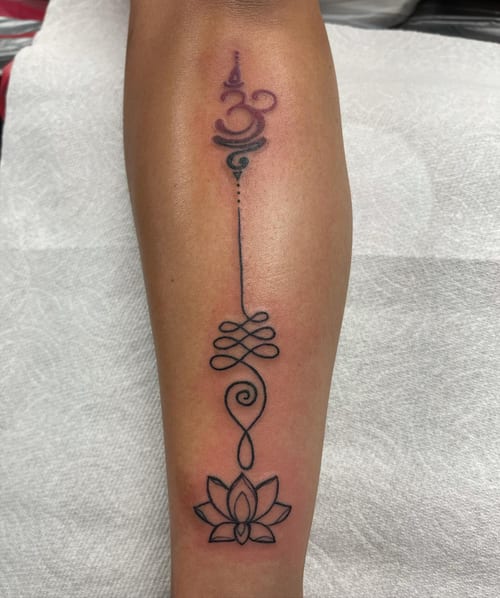 A minimalist lotus tattoo with delicate linework on the forearm, featuring a simple and elegant design — by Sandra Price, los angeles