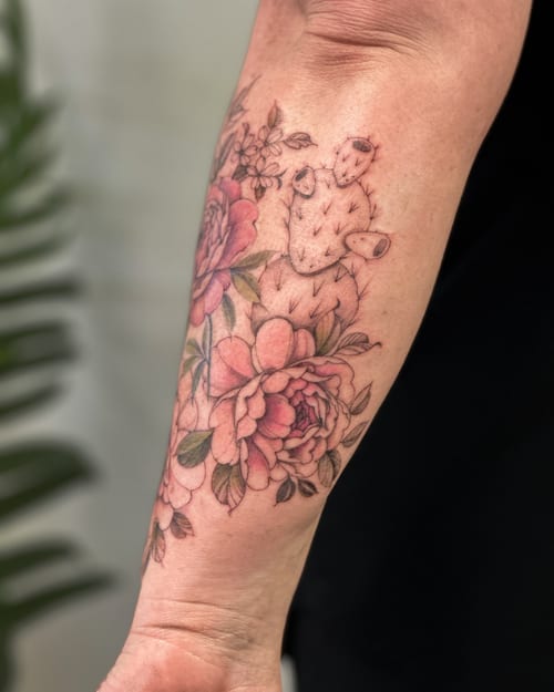 A delicate color tattoo of a cactus and flowers on the forearm, featuring fine line and botanical elements — by Melanie Benoit, los angeles