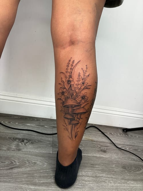 A fine line black and grey tattoo on the calf featuring detailed flowers and mushrooms with delicate shading — by Edgar Armas Rodriguez, los angeles