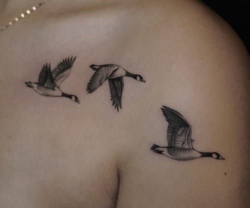 A black and grey realism tattoo of three flying birds on the shoulder, with detailed shading and fine line work — by Jian Liang, los angeles