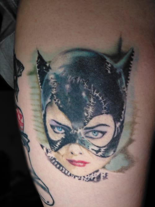 A realistic color portrait of a woman in a cat-themed mask on the thigh, featuring detailed shading and vibrant colors — by anoetic.designs.ultd, los angeles