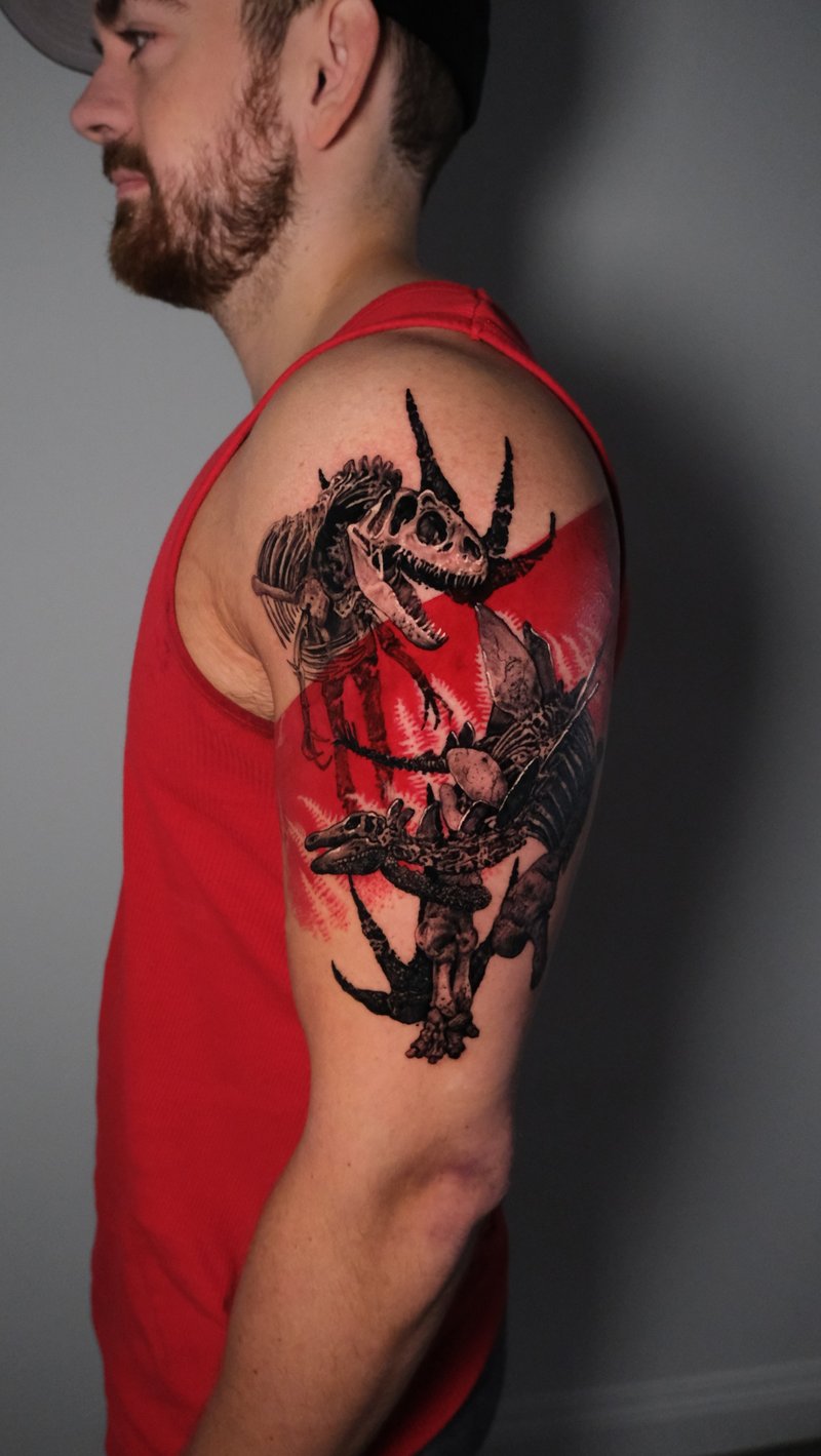 black and red trash polka dinosaur skeleton tattoo by Nik Lucas, a tattoo artist in mid-city, los angeles
