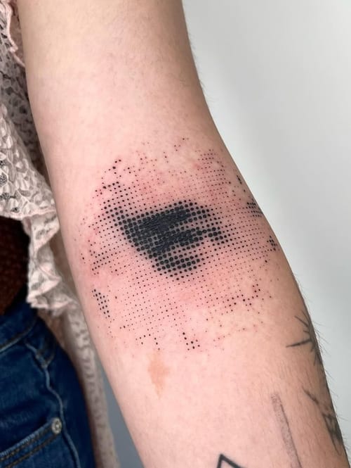 An abstract dotwork tattoo of a hand on the forearm, featuring a pixelated effect in black ink — by Level tattoo, los angeles