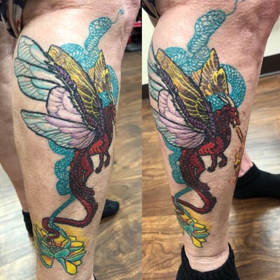 A colorful dragon with wings tattoo on the leg, featuring bold illustrative style and vibrant colors — by Sandra Price, los angeles