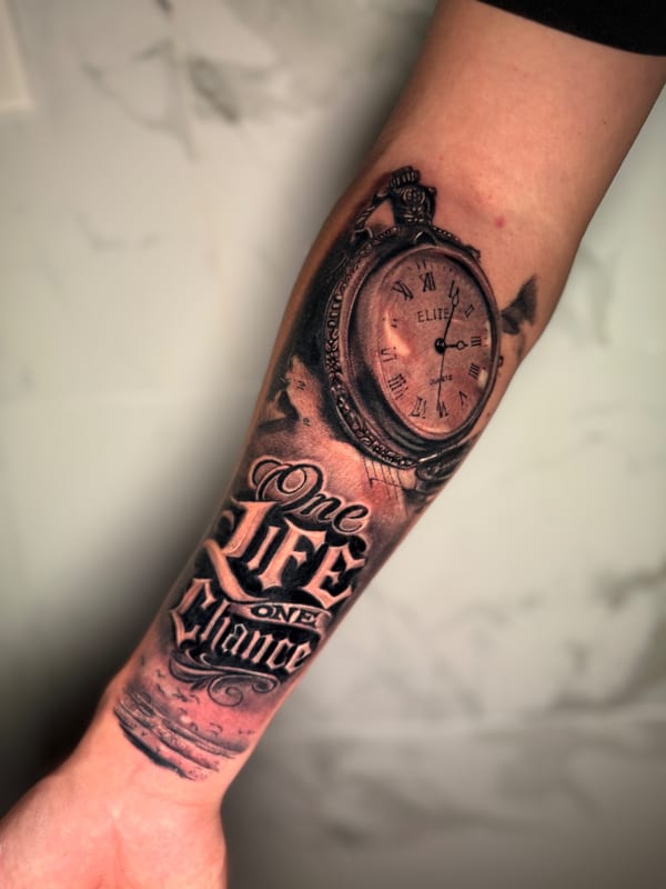 black and grey realism tattoo of an open pocket watch above script reading one life one chance on the forearm by 钟逸政, a tattoo artist in orange, california