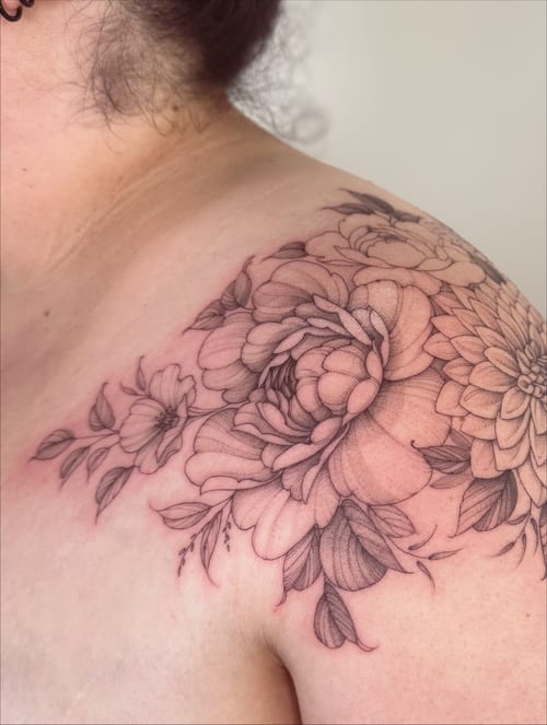 A delicate black and grey floral bouquet tattoo on the shoulder with fine line detailing — by Melanie Benoit, los angeles