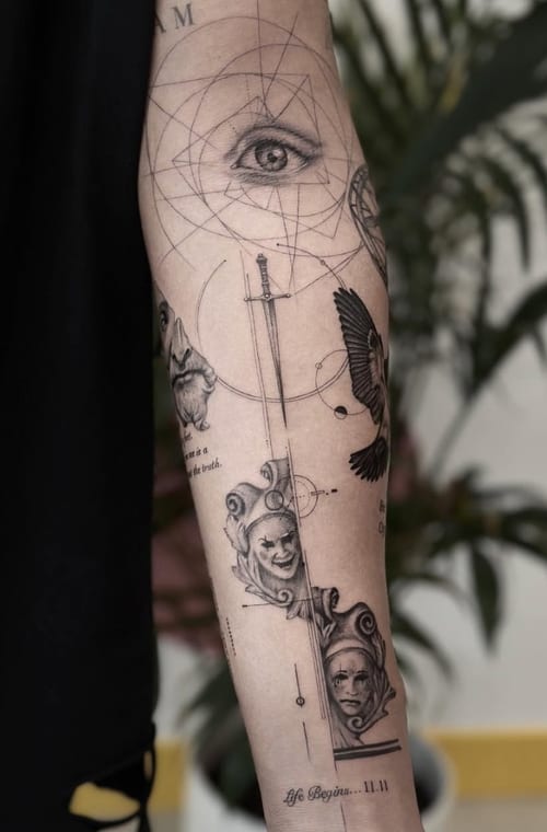 A black and grey fine line tattoo on the forearm featuring an eye, geometric patterns, a bird, and faces with script elements — by Jian Liang, los angeles