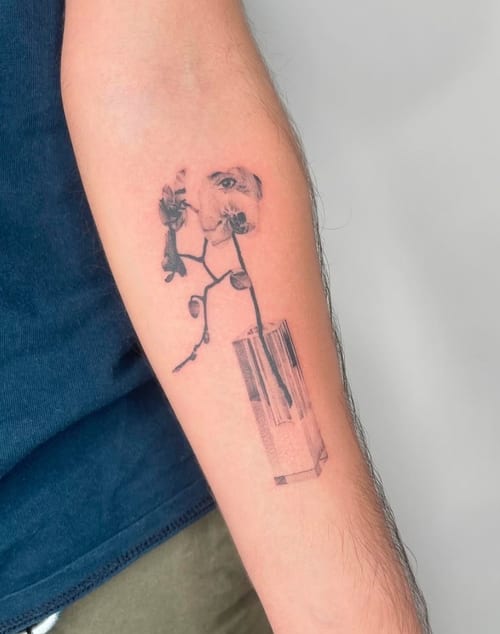 A fine line black and grey tattoo of flowers with a geometric element on the forearm, featuring delicate linework and shading — by Level tattoo, los angeles