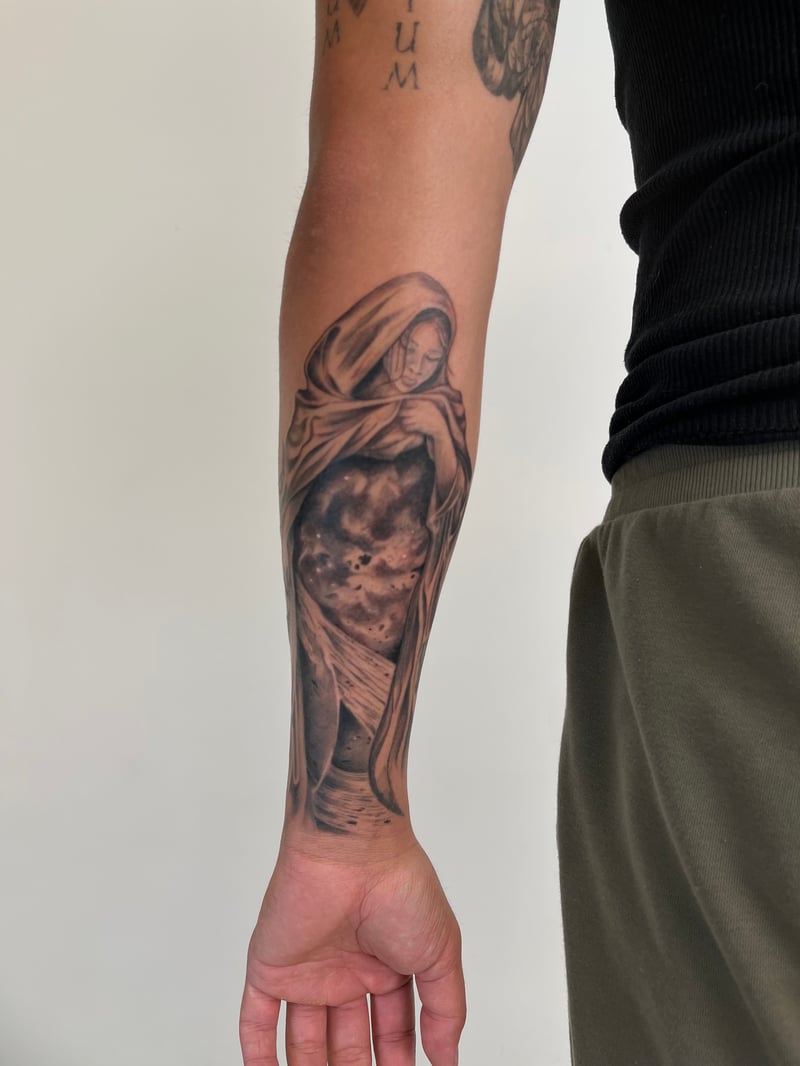 black and grey realism tattoo of a veiled Madonna by Dean Felipe, a black and grey realism tattoo artist in downtown los angeles
