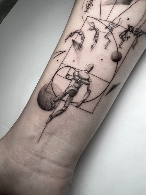 An abstract black and grey linework tattoo on the forearm, depicting a stylized human figure with geometric elements — by INKEDBy_G, los angeles