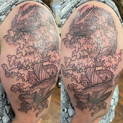 A detailed black and grey linework tattoo of a dragon entwined in a tree on the upper arm, featuring intricate Japanese style elements — by Sandra Price, los angeles