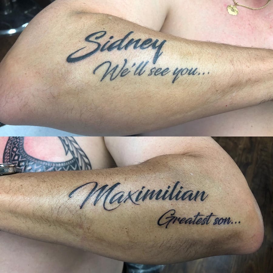 A black script lettering tattoo on the arm featuring names and phrases in a memorial style — by Sandra Price, los angeles