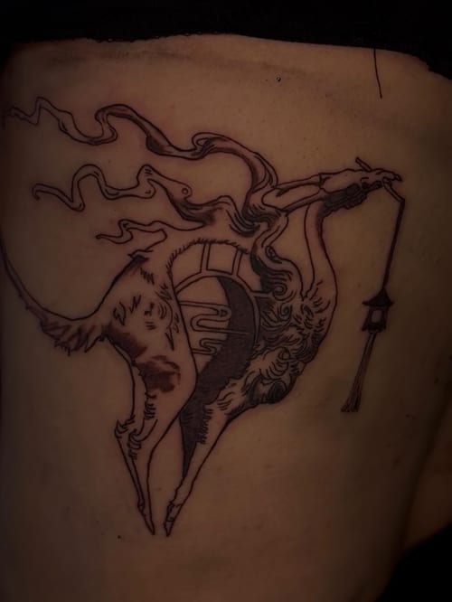 An abstract black and grey linework tattoo of a stylized animal with flowing lines and intricate details on the rib — by Hannah , los angeles