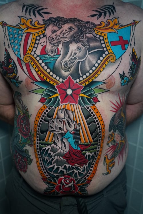A vibrant American Traditional style tattoo covering the full back, featuring horses, a woman in the ocean, and roses, with bold outlines and bright colors — by Megan Rose, los angeles