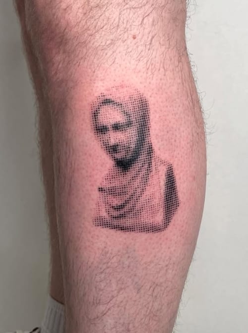 A black and grey dotwork portrait tattoo on the calf, featuring a stylized bust with intricate dot shading — by Level tattoo, los angeles