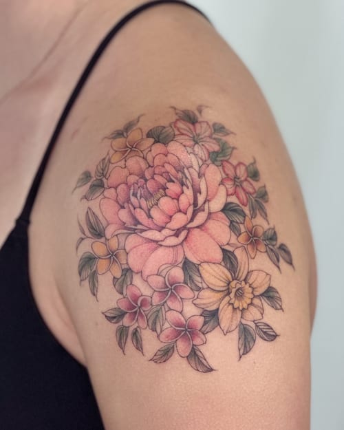 A colorful floral bouquet tattoo on the shoulder featuring fine line work and delicate shading — by Melanie Benoit, los angeles