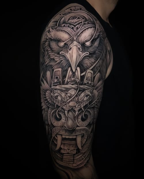 A detailed black and grey tattoo of an eagle with bio-mechanical elements on the upper arm, featuring intricate linework and shading — by imindisoul, los angeles
