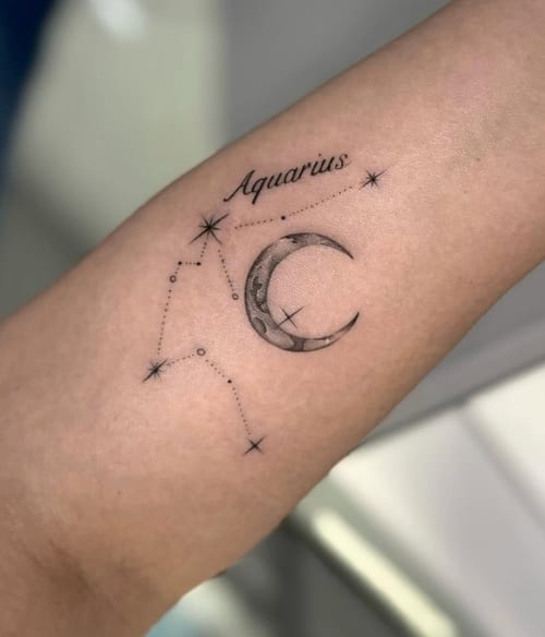 A minimalist black and grey tattoo of the Aquarius constellation with a crescent moon on the forearm, featuring fine line work and subtle shading — by otaybeatdown, los angeles