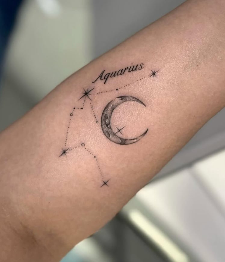 A minimalist black and grey tattoo of the Aquarius constellation with a crescent moon on the forearm, featuring fine line work and subtle shading — by otaybeatdown, los angeles