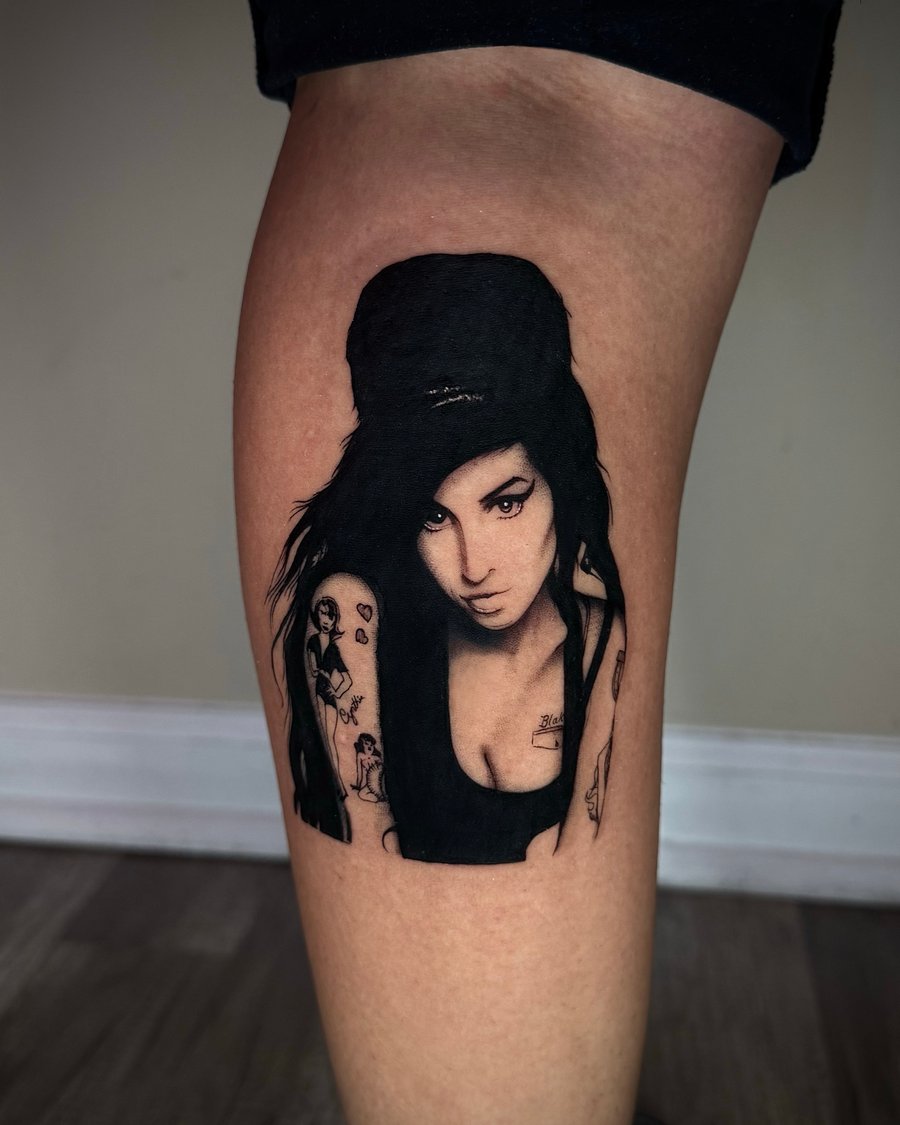 A black and grey realism portrait of a woman on the thigh, featuring detailed shading and lifelike features — by emily, los angeles