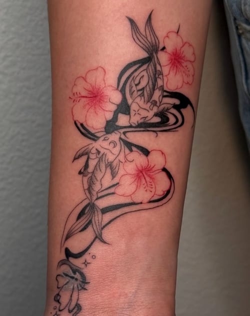 A fine line tattoo of two koi fish intertwined with red flowers on the forearm, combining black ink with subtle red accents — by NJ TATTOOZ, los angeles