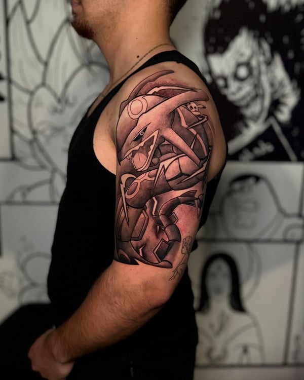 A bold black and grey tattoo of a robotic creature on the upper arm, featuring an illustrative anime style — by zealous, los angeles
