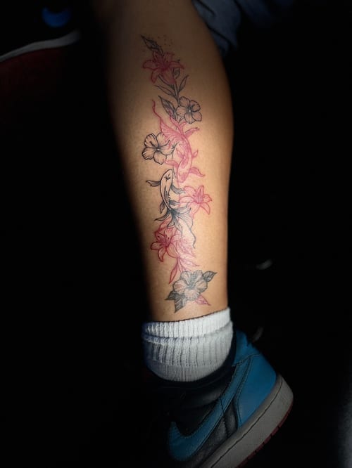 A fine line tattoo of flowers on the calf, featuring delicate black outlines with pink shading — by Mr._Folks, los angeles