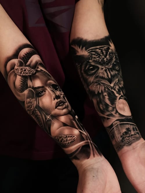 A detailed black and grey tattoo featuring a woman's portrait with a snake and an owl on the forearm — by Johnny Ayala, los angeles