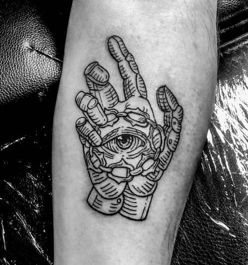 A black and grey tattoo on the calf depicting a stylized hand with an eye in the center, featuring bold linework and intricate details — by Tag Devilish, los angeles