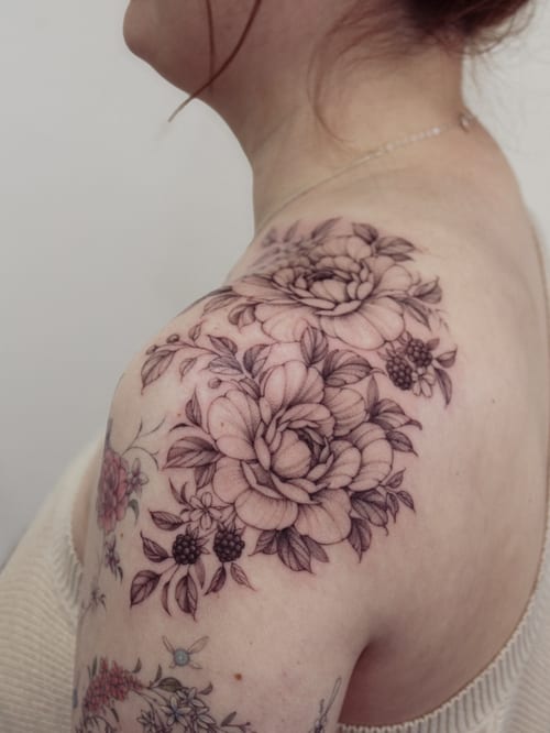 A delicate black and grey floral bouquet tattoo on the shoulder with fine line detailing — by Melanie Benoit, los angeles