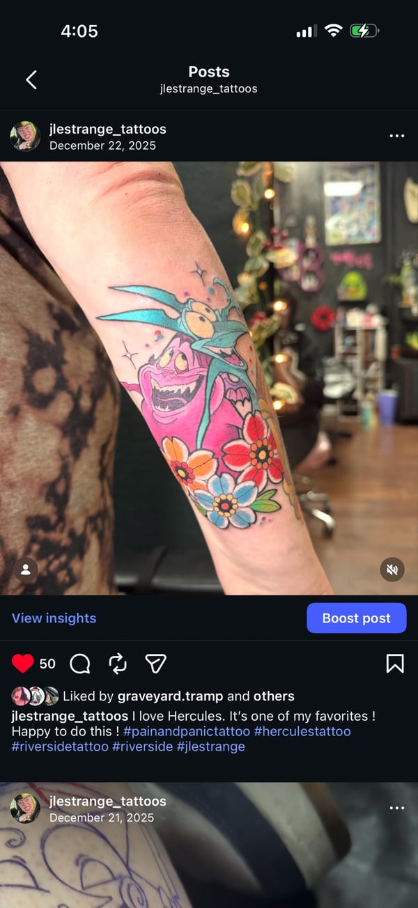A colorful Neo-Traditional tattoo on the forearm featuring a cartoonish creature with flowers, characterized by bold outlines and vibrant colors — by Jessica Linden, riverside, ca