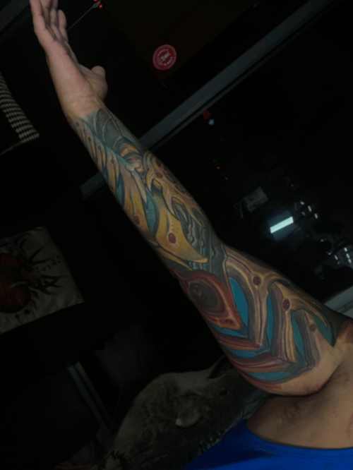 full color sleeve of flowing bio-organic shapes in teal, amber and rust running shoulder to wrist — by tyler_whitlock, los angeles