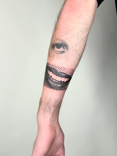 blackwork eye and mouth tattoo — by Level tattoo, los angeles