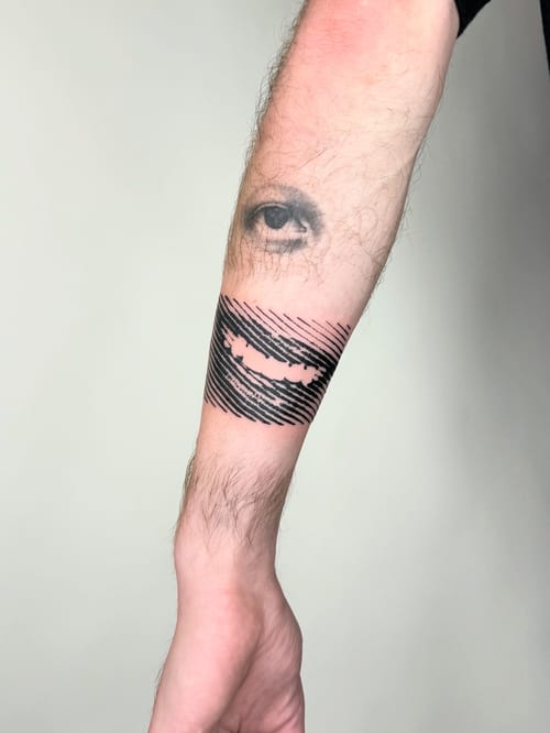 blackwork eye and mouth tattoo — by Level tattoo, los angeles