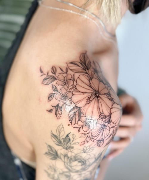 A delicate black and grey floral bouquet tattoo on the shoulder, featuring fine line work and intricate details — by Melanie Benoit, los angeles