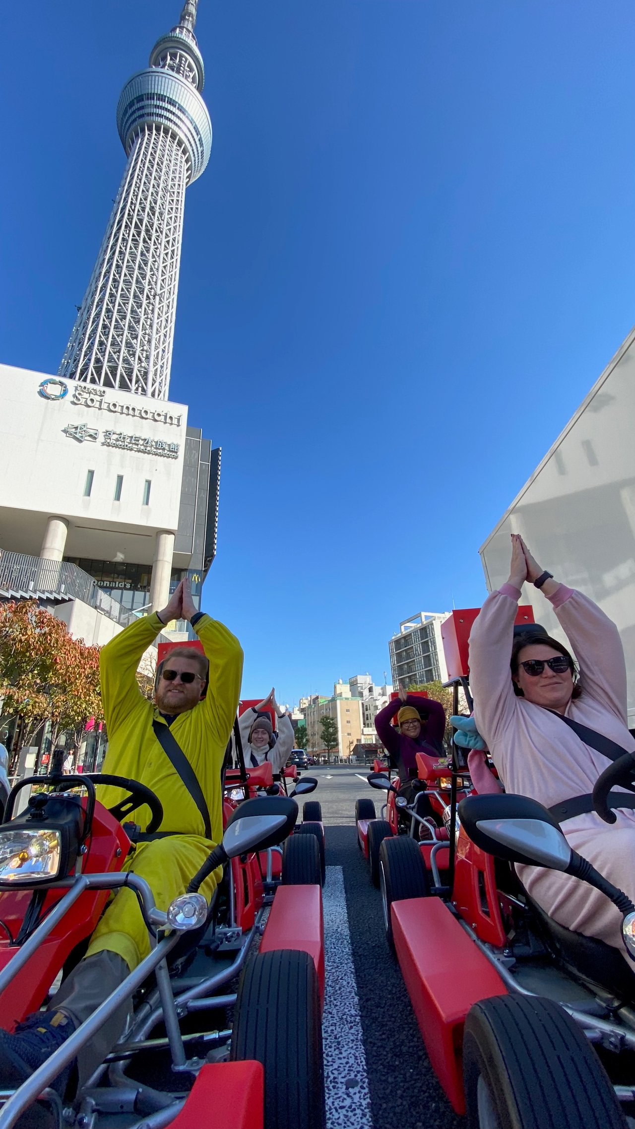 Go karts lined up with Tokyo Skytree visible in the background