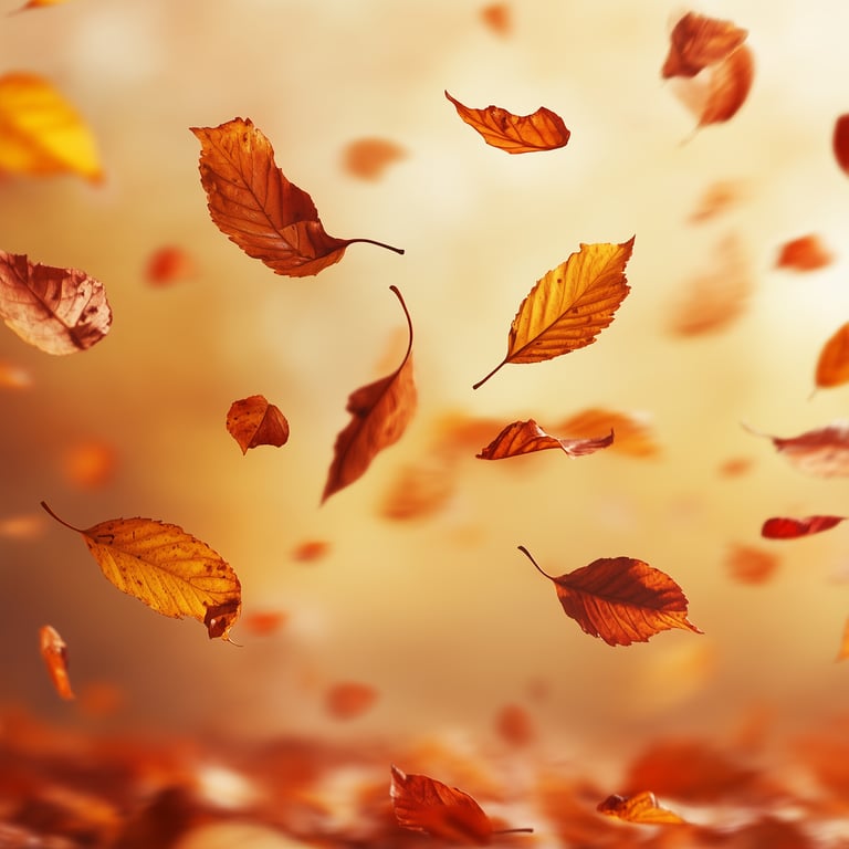 Falling autumn leaves in soft focus against a warm, blurred background.